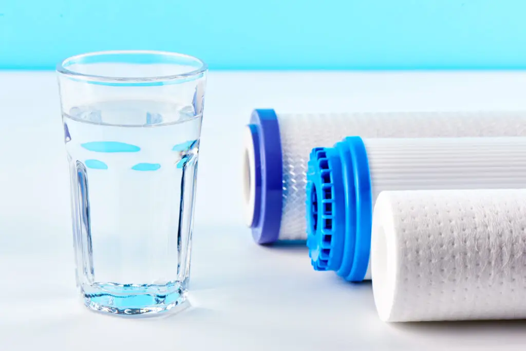 Glass of water next to replacement filter cartridges