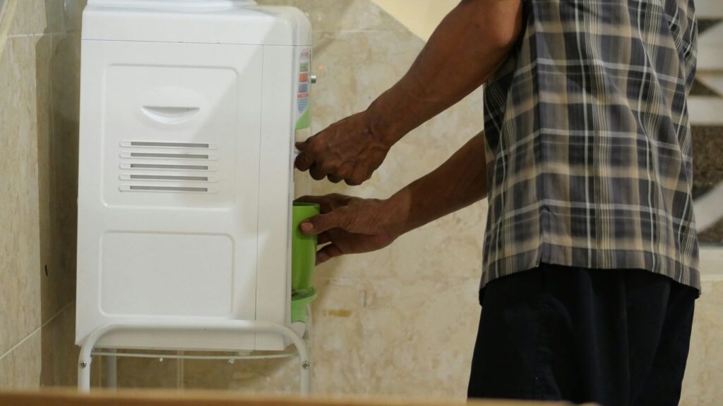 a man is putting something in a cooler